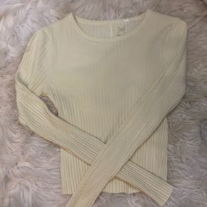 cropped long sleeve tee, slight ruffles at bottom + sleeves ribbed not see thru